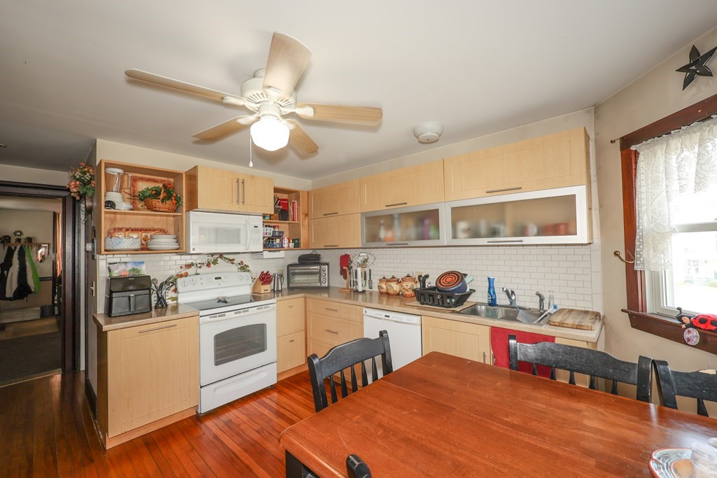 1450 Main Street Athol, MA 01331 - Photo 10 of 42 a kitchen with a stove a refrigerator and a dining table