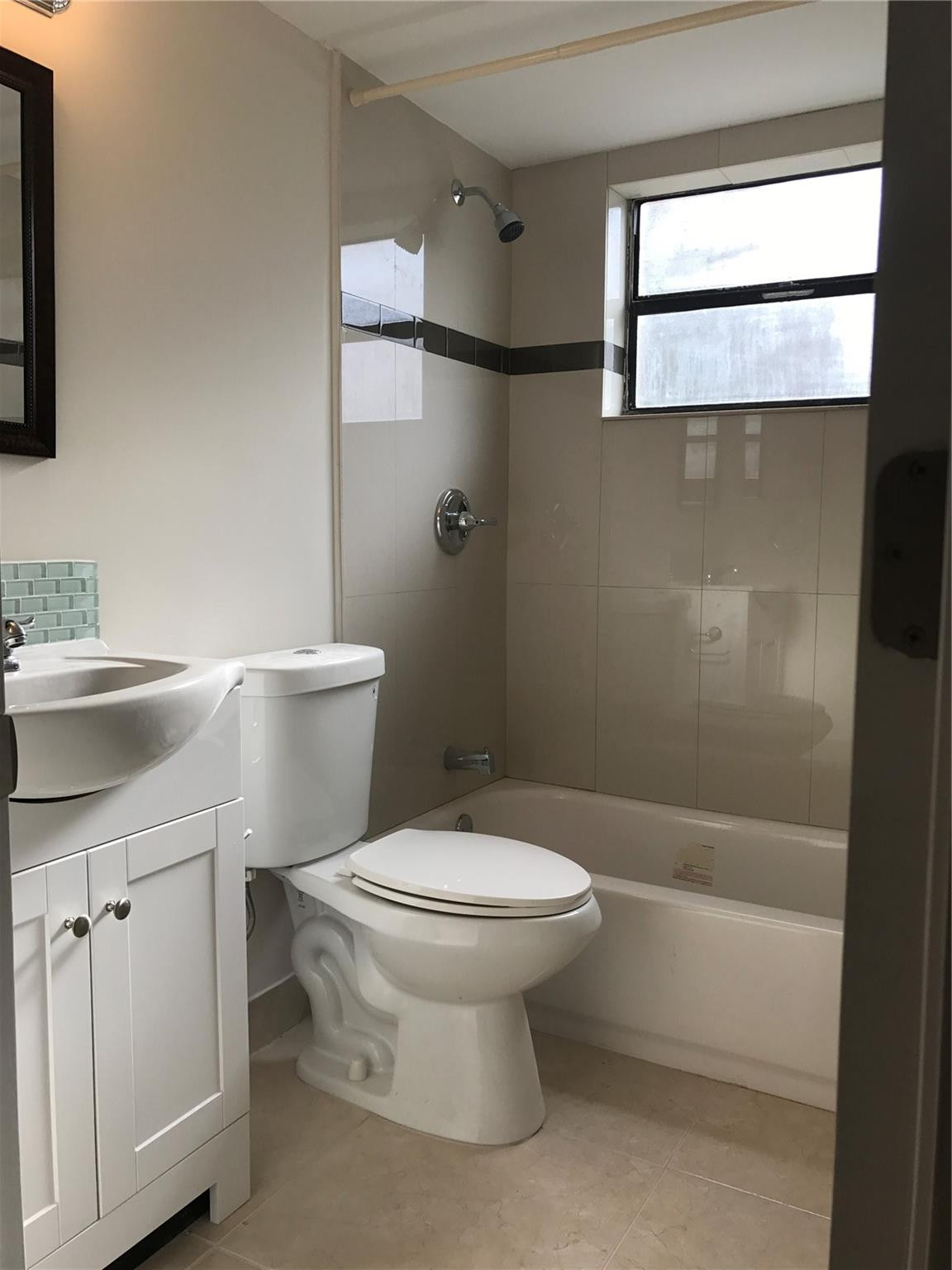 10053 Winding Lake Road, Unit 104 Sunrise, FL 33351 - Photo 12 of 44 a white toilet sitting next to a bathroom sink