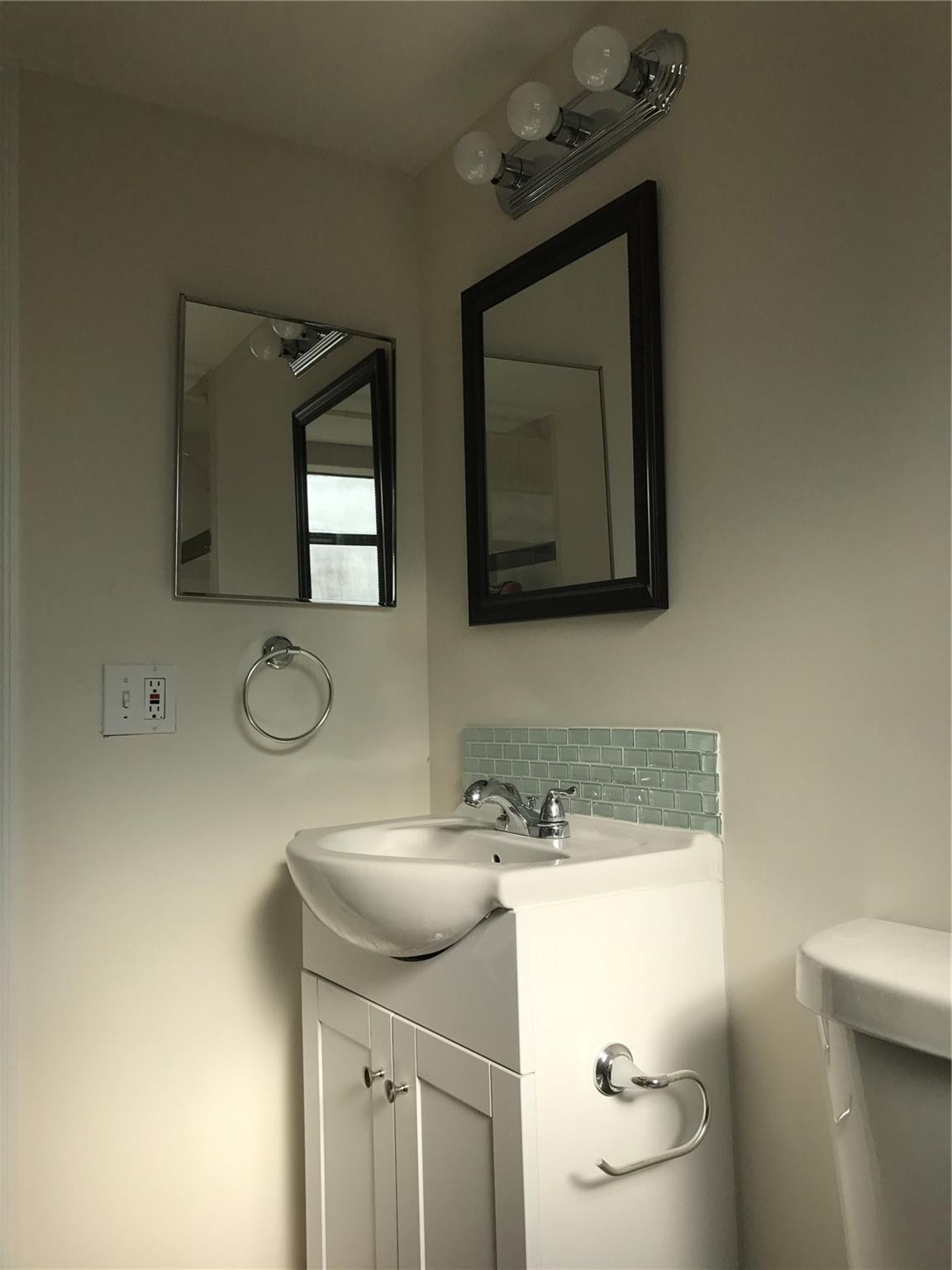 10053 Winding Lake Road, Unit 104 Sunrise, FL 33351 - Photo 13 of 44 a bathroom with a toilet sink and mirror