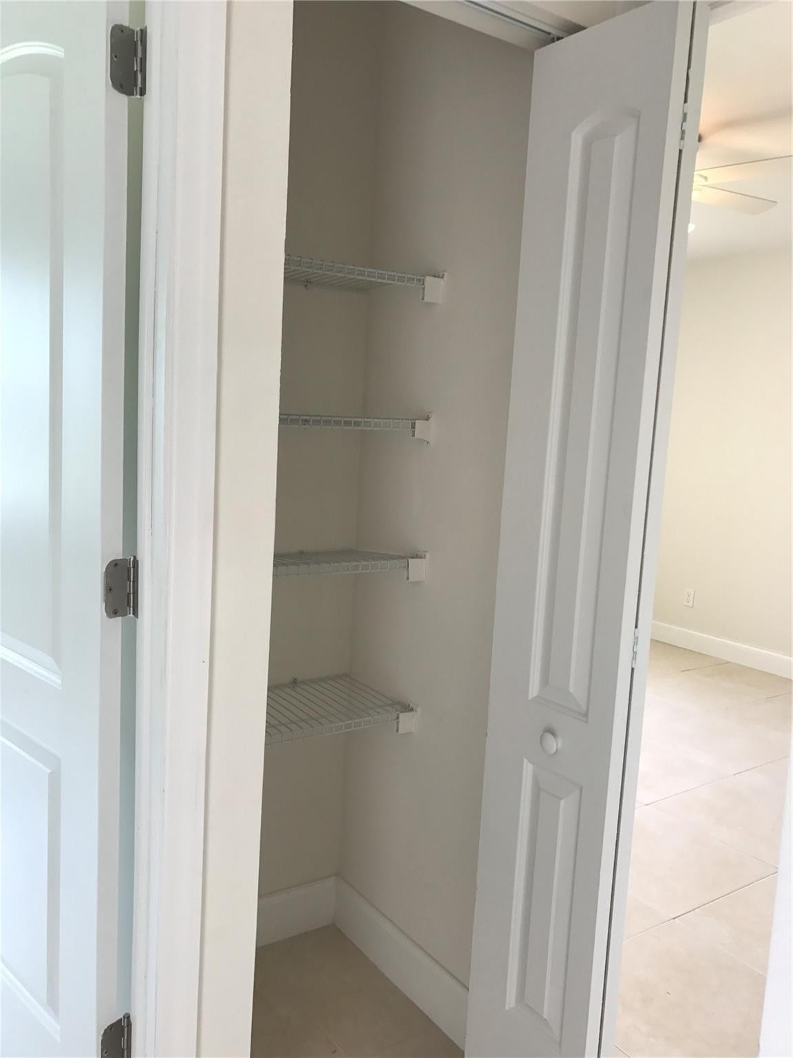 10053 Winding Lake Road, Unit 104 Sunrise, FL 33351 - Photo 15 of 44 a bathroom with a glass shower door