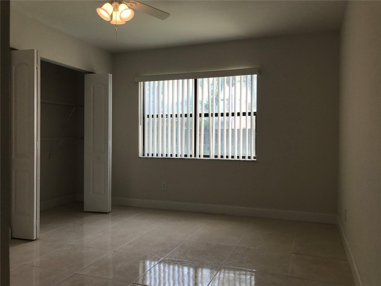 10053 Winding Lake Road, Unit 104 Sunrise, FL 33351 - Photo 16 of 44 an empty room with a window