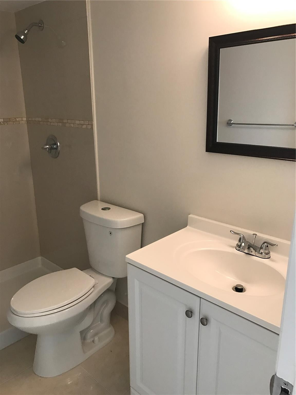 10053 Winding Lake Road, Unit 104 Sunrise, FL 33351 - Photo 20 of 44 a white toilet sitting next to a bathroom sink