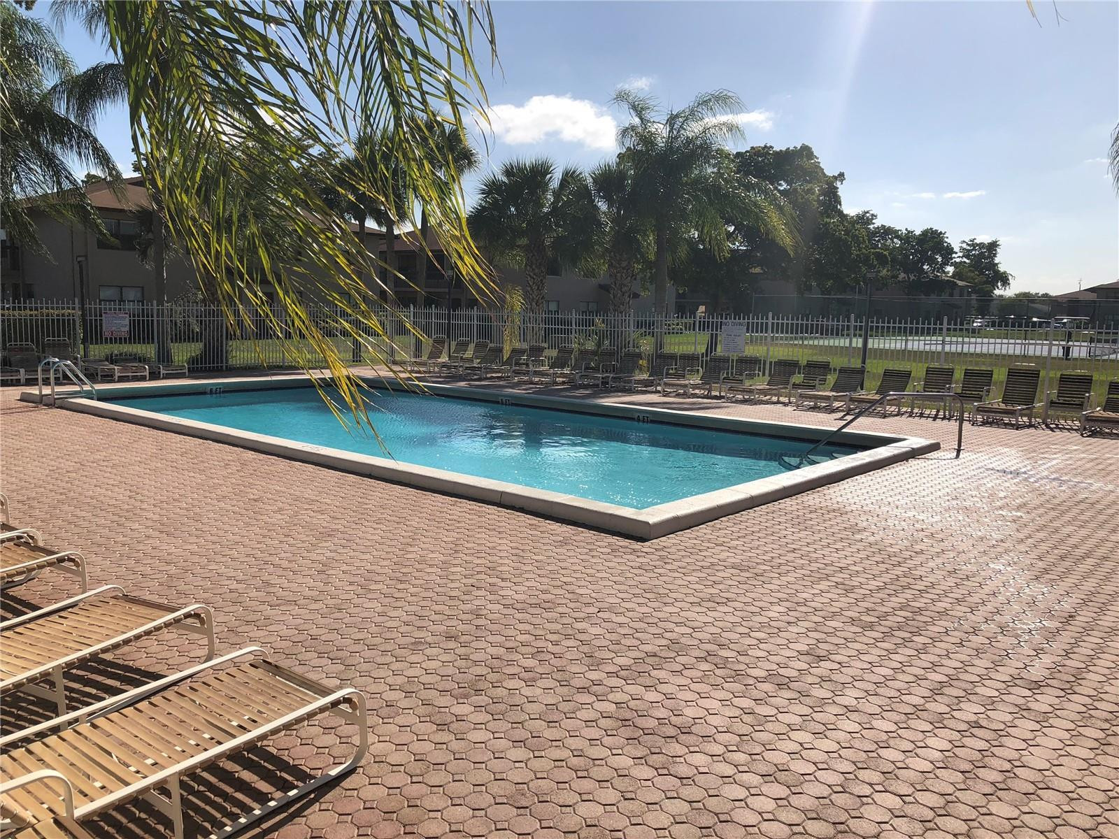 10053 Winding Lake Road, Unit 104 Sunrise, FL 33351 - Photo 26 of 44 a view of a swimming pool with a yard