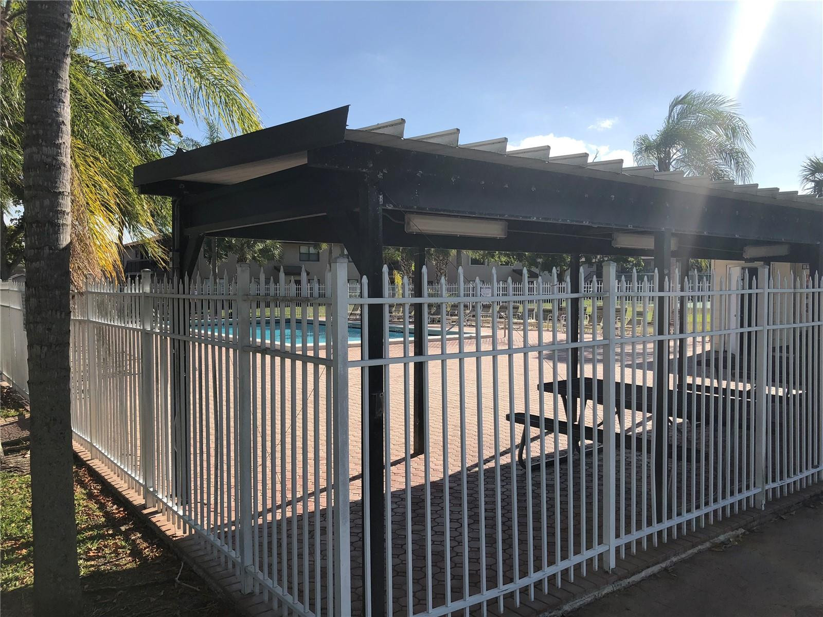 10053 Winding Lake Road, Unit 104 Sunrise, FL 33351 - Photo 28 of 44 a view of a house with a wooden fence