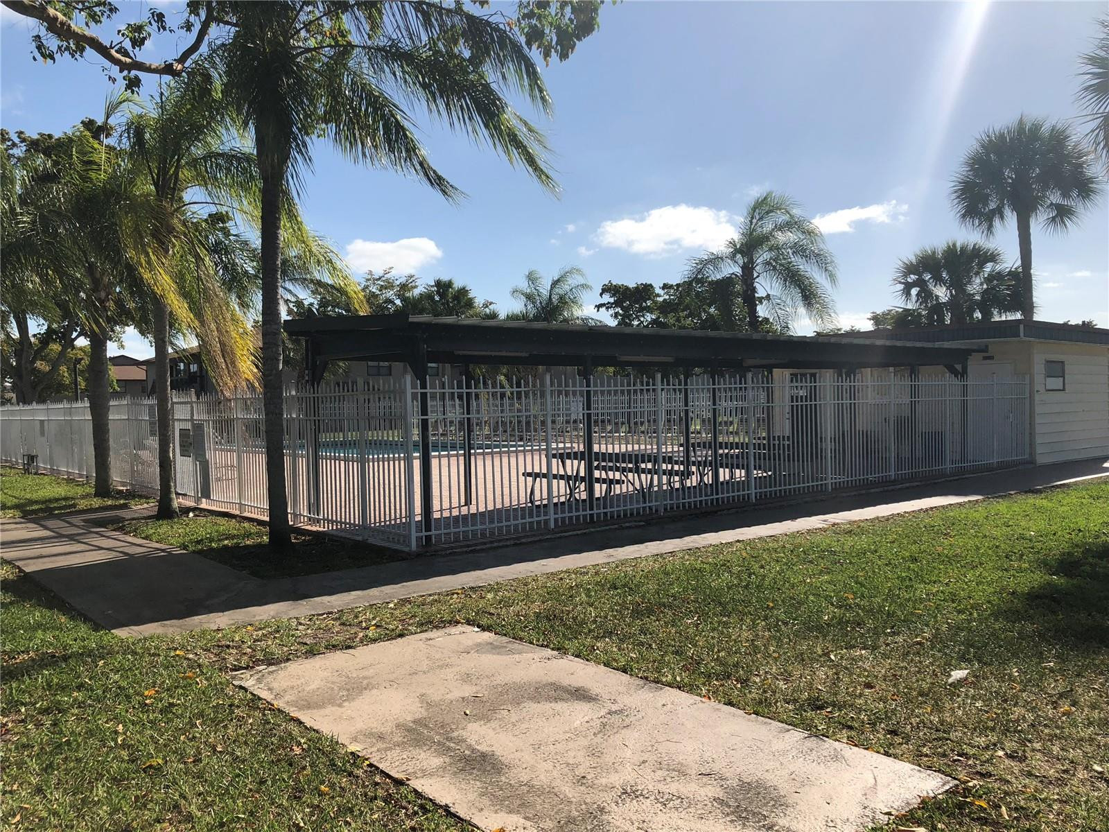 10053 Winding Lake Road, Unit 104 Sunrise, FL 33351 - Photo 29 of 44 a view of a backyard with a garden