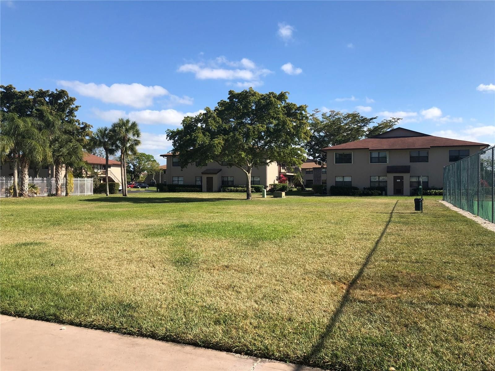10053 Winding Lake Road, Unit 104 Sunrise, FL 33351 - Photo 35 of 44 a view of a house with a yard