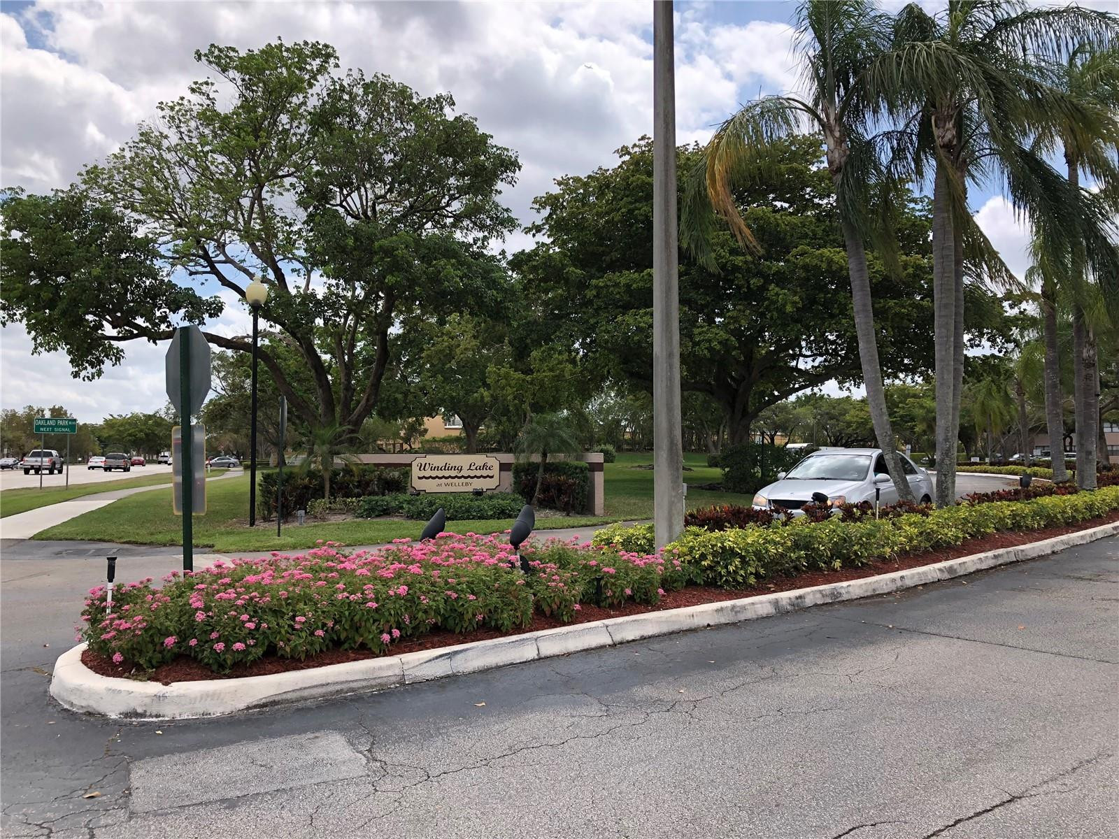 10053 Winding Lake Road, Unit 104 Sunrise, FL 33351 - Photo 37 of 44 a view of a garden with palm tree