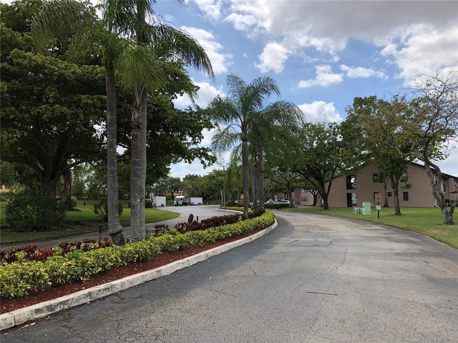 10053 Winding Lake Road, Unit 104 Sunrise, FL 33351 - Photo 39 of 44 a view of a park with large trees