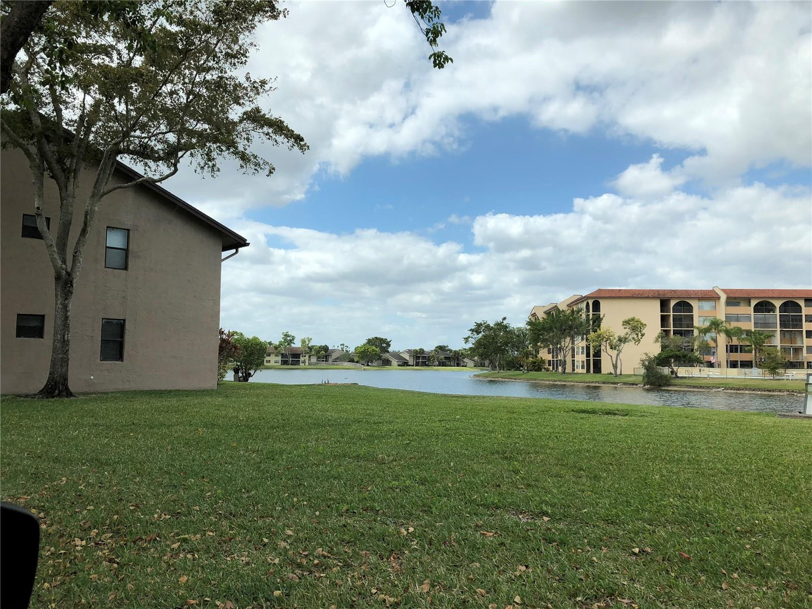 10053 Winding Lake Road, Unit 104 Sunrise, FL 33351 - Photo 40 of 44 a view of a garden with a house in the background