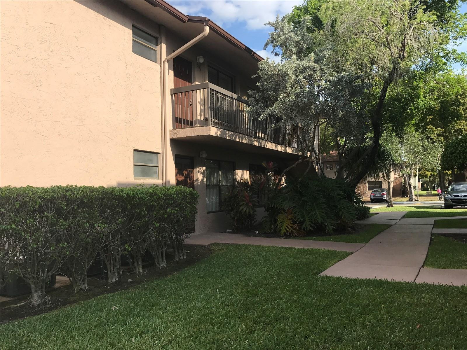 10053 Winding Lake Road, Unit 104 Sunrise, FL 33351 - Photo 42 of 44 a view of a front of house with a yard