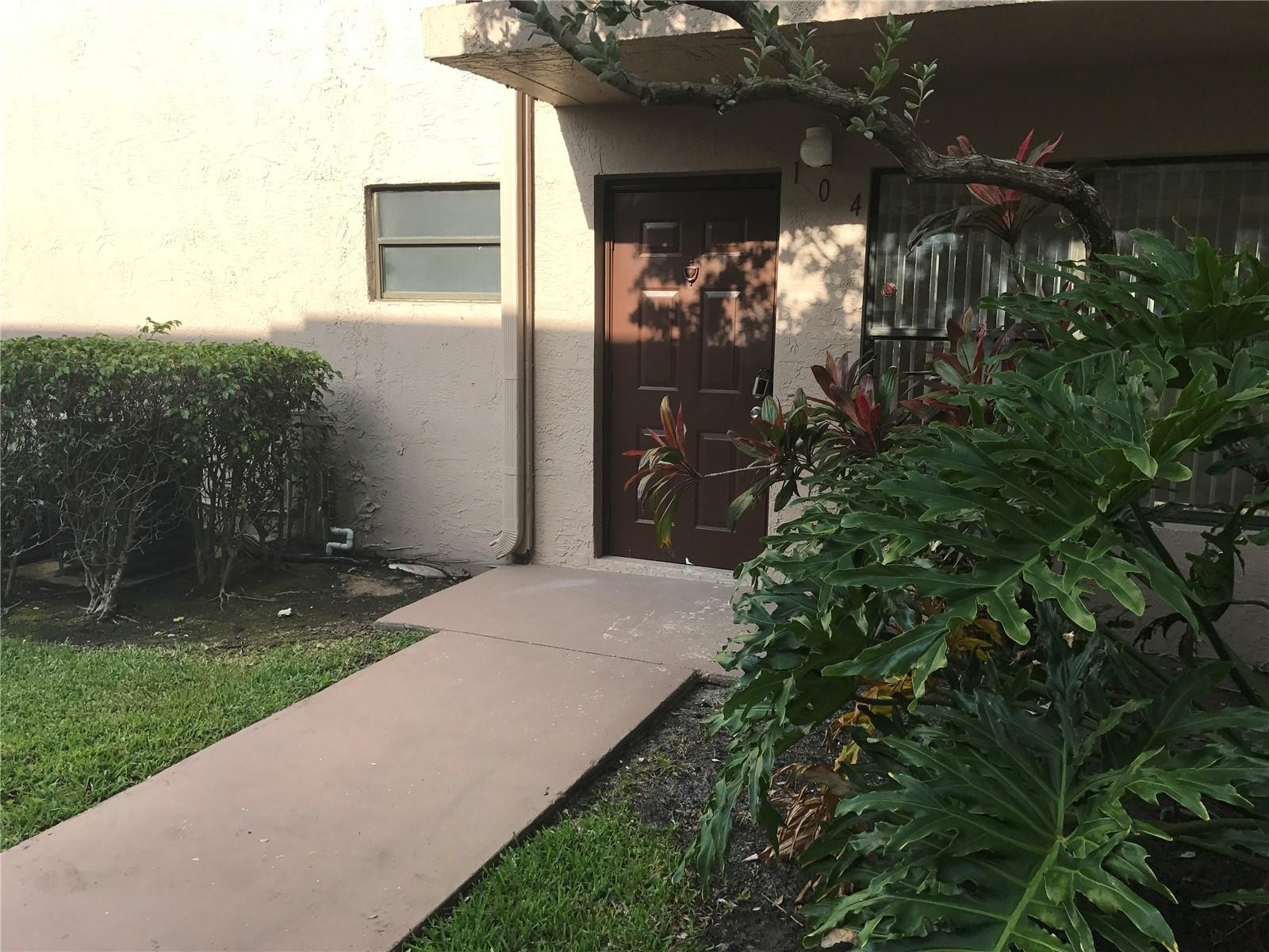 10053 Winding Lake Road, Unit 104 Sunrise, FL 33351 - Photo 43 of 44 a couple of flower plants in front of house