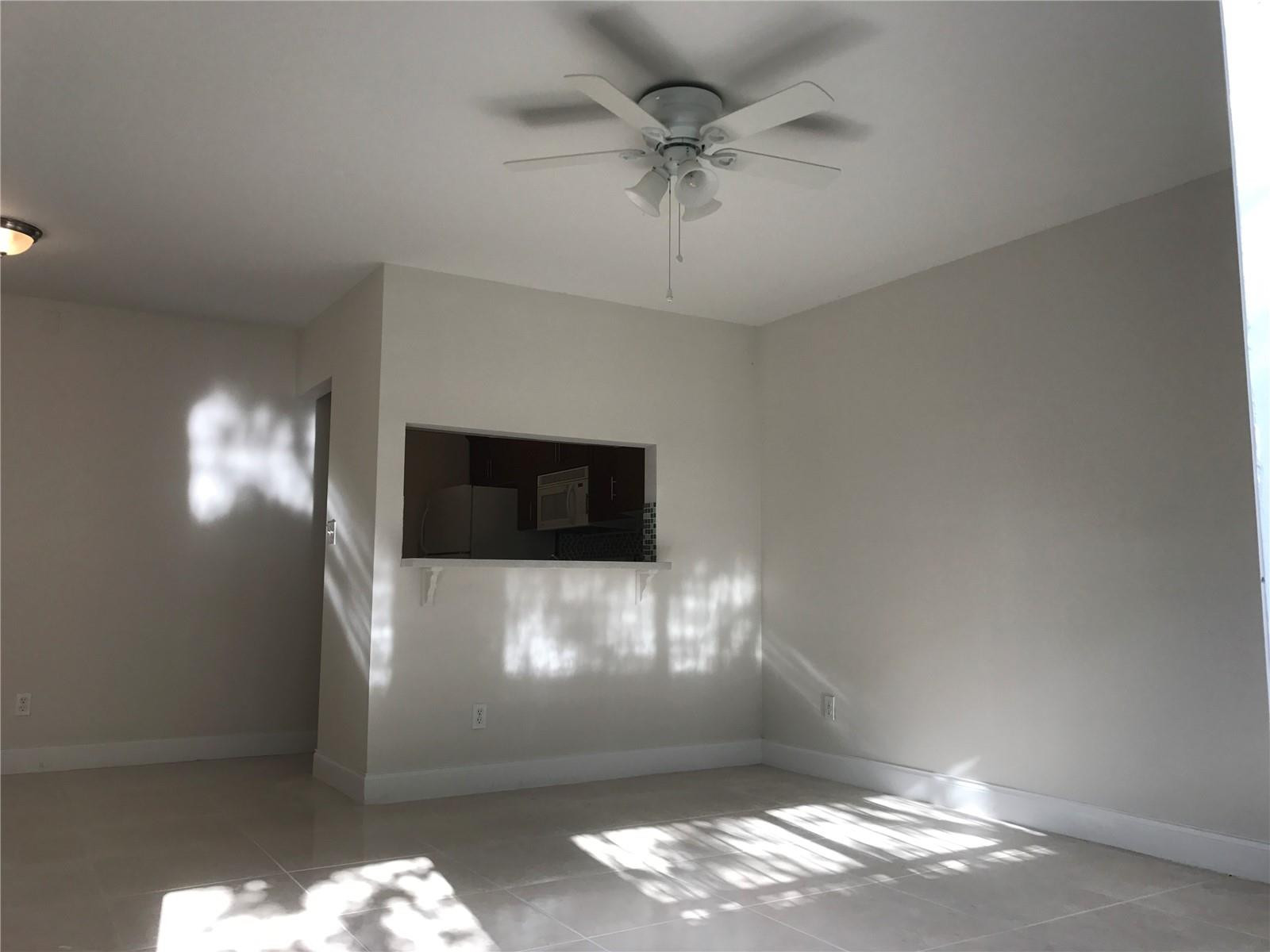 10053 Winding Lake Road, Unit 104 Sunrise, FL 33351 - Photo 7 of 44 a view of a big room with windows and fireplace