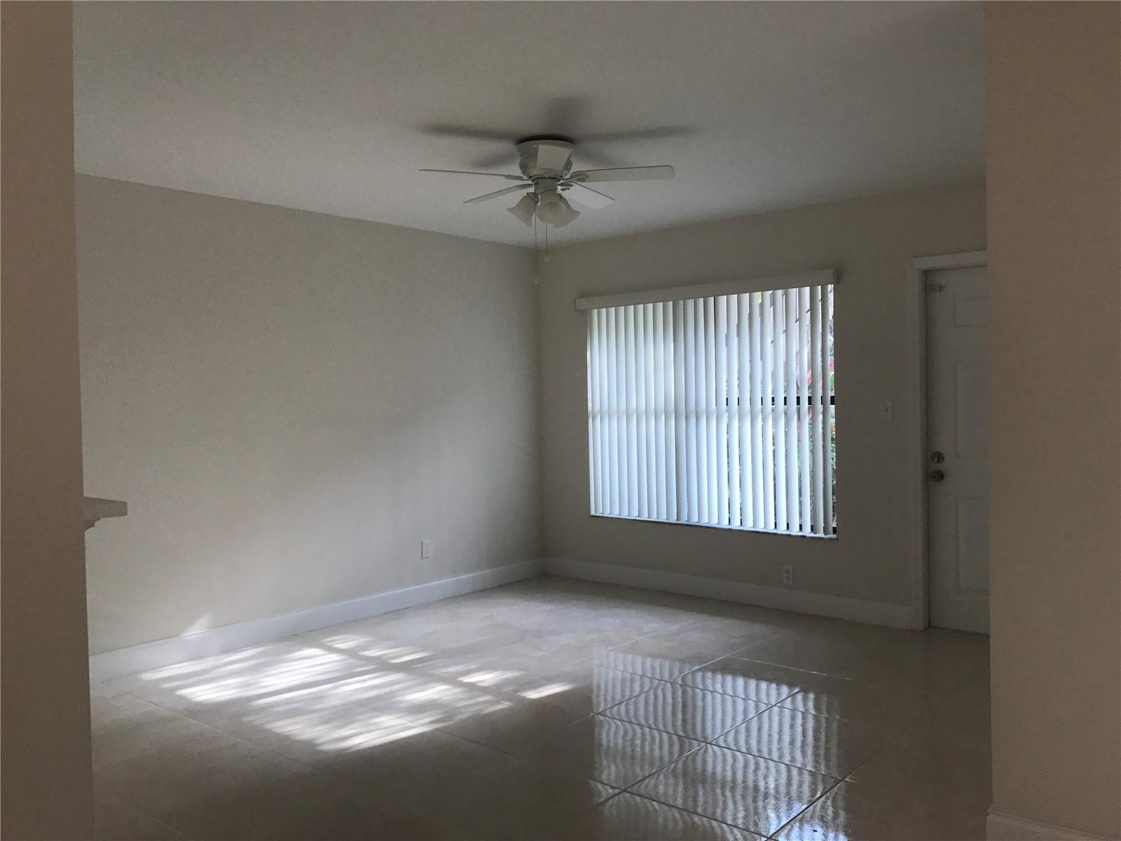 10053 Winding Lake Road, Unit 104 Sunrise, FL 33351 - Photo 9 of 44 a view of an empty room and window