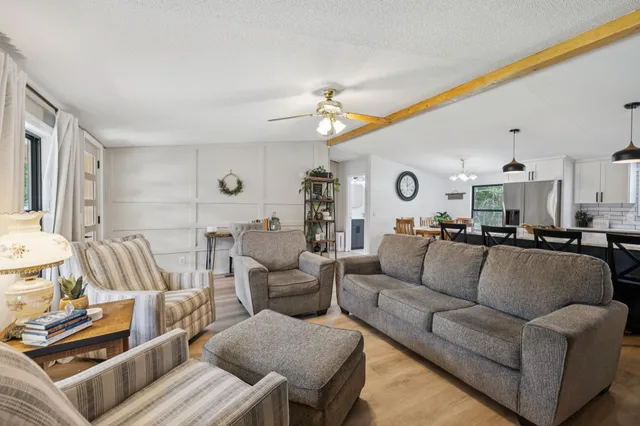 a bedroom with a large bed and a flat tv screen on dresser