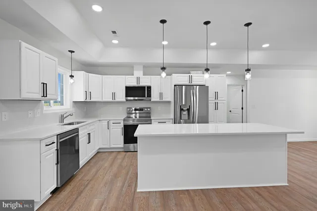 a large kitchen with stainless steel appliances