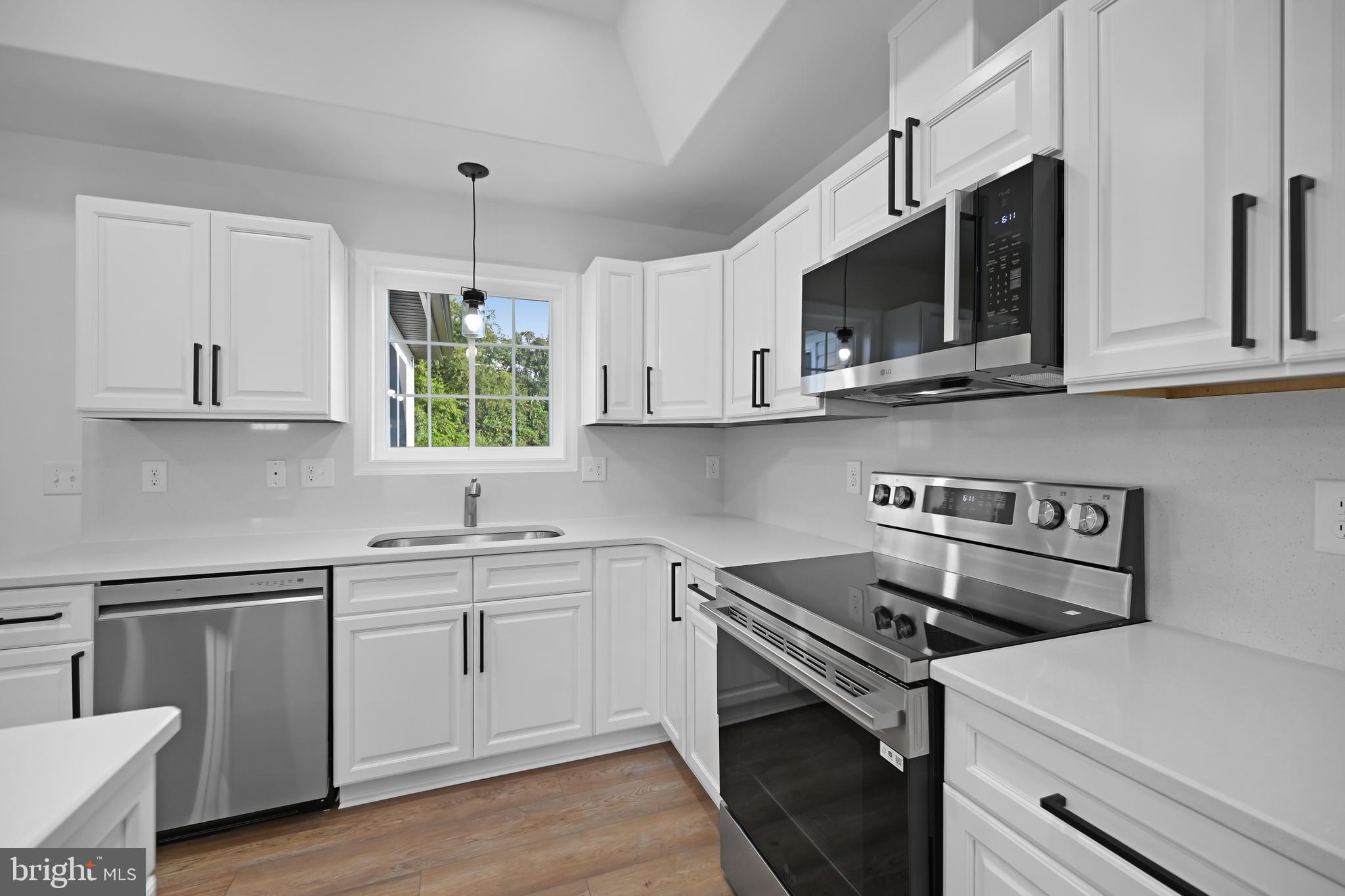 23180 Slaughter Neck Road Lincoln, DE 19960 - Photo 12 of 29 a kitchen with stainless steel appliances white cabinets granite counter tops and a stove