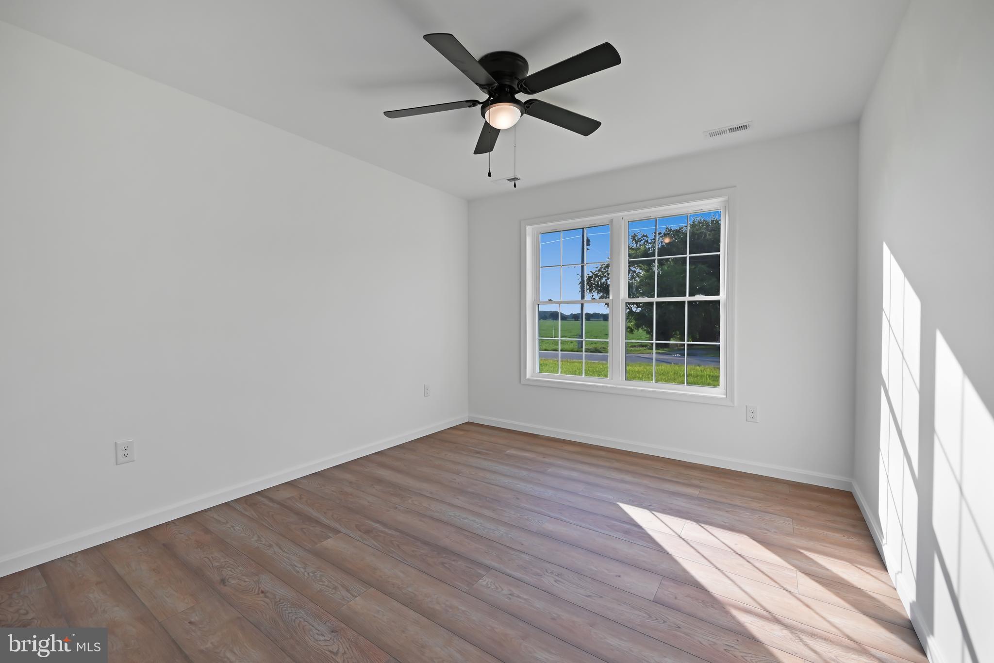 23180 Slaughter Neck Road Lincoln, DE 19960 - Photo 17 of 29 an empty room with windows and fan