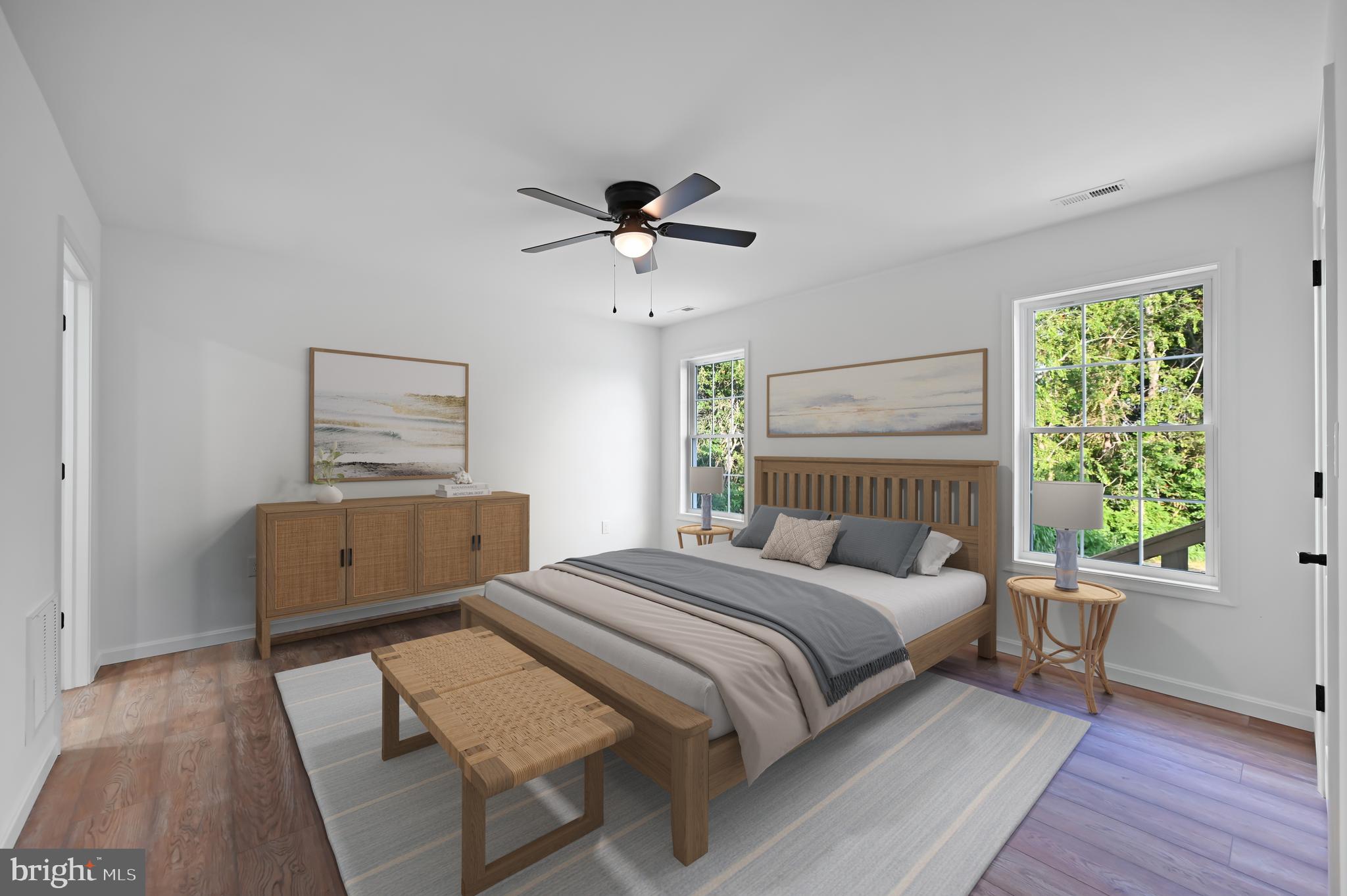 23180 Slaughter Neck Road Lincoln, DE 19960 - Photo 21 of 29 a bedroom with a bed and wooden floor