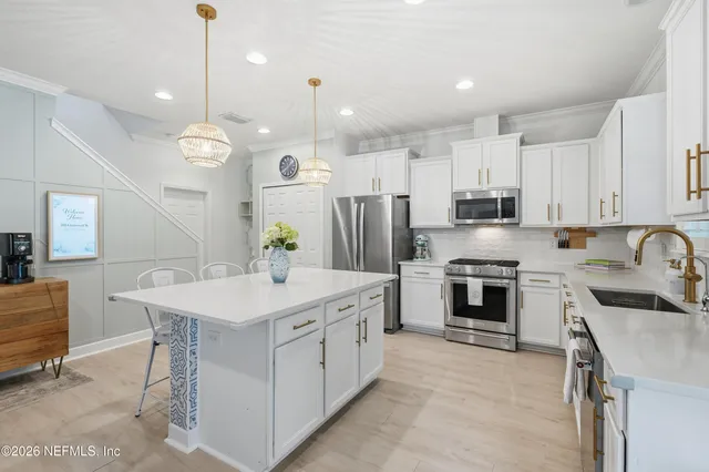 a hallway with furniture and a flat screen tv