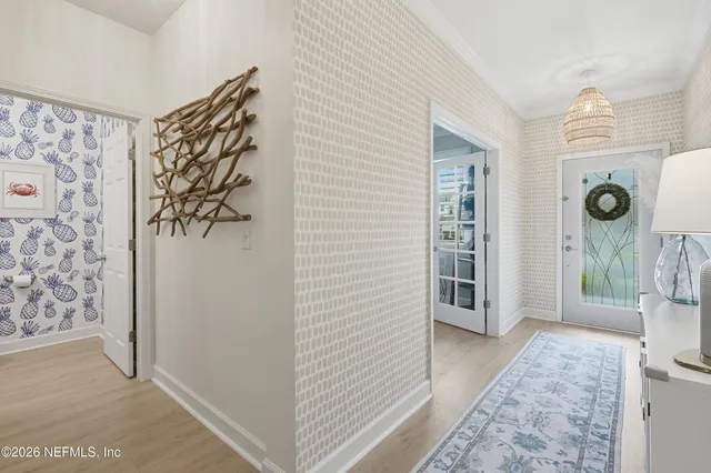 a bed room with a bed a dresser and painting on the wall