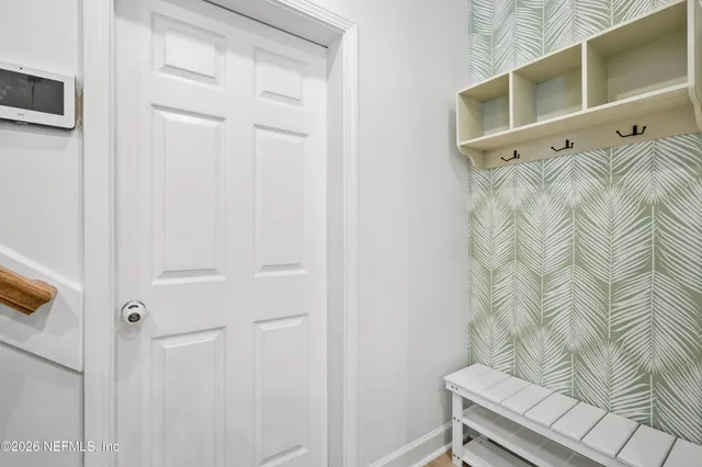 a bedroom with furniture and a large window