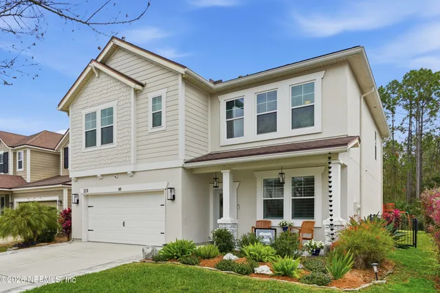 a living room with fireplace furniture and a flat screen tv