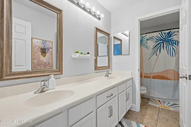 a view of a fountain in front of a house with a big yard