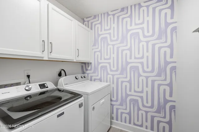 a view of a swimming pool with a lounge chair and palm trees