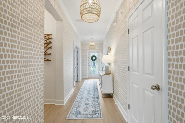 a view of a dining room with furniture and chandelier