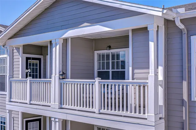 a view of a patio with couches table and chairs with potted plants
