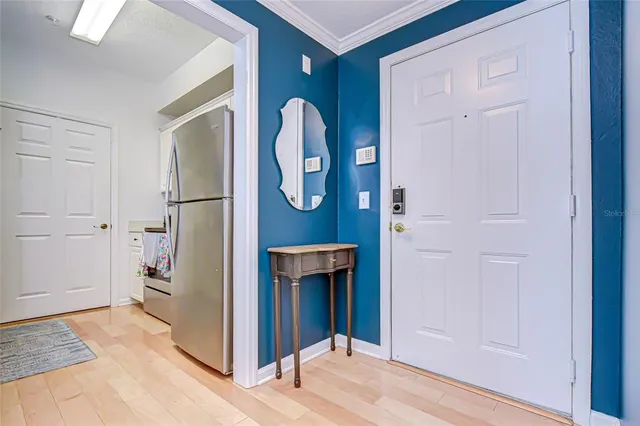 a kitchen with stainless steel appliances a stove a chimney and cabinets