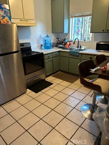 a kitchen with a sink cabinets and appliances