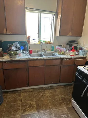 a room with granite countertop cabinets and a sink