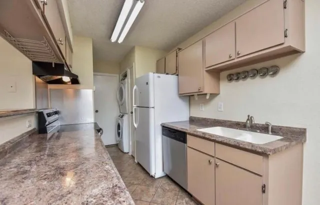 a kitchen with refrigerator and cabinets