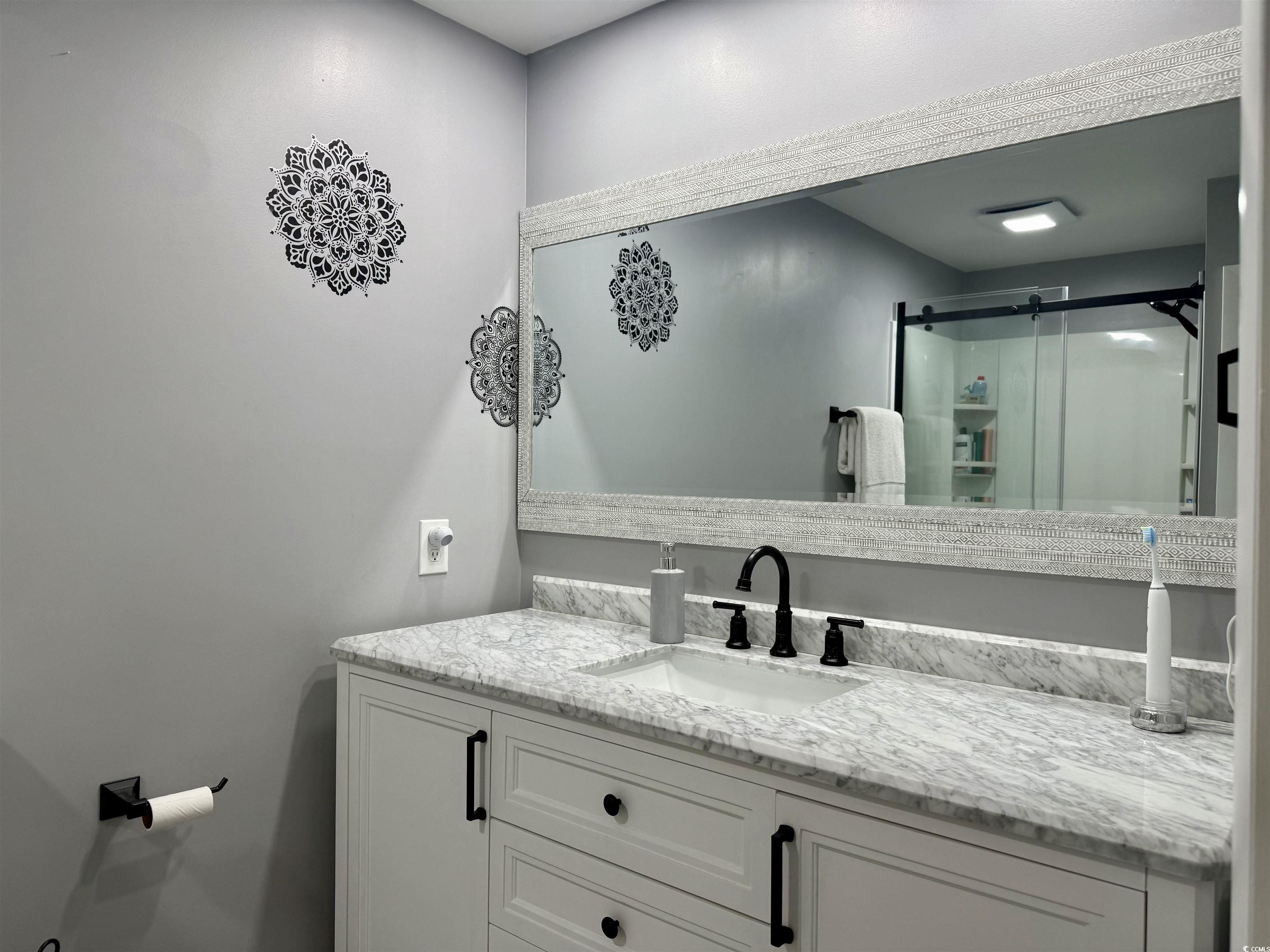 527 Sandpebble Surfside Beach, SC 29575 - Photo 12 of 31 Bathroom with vanity and a shower with shower door