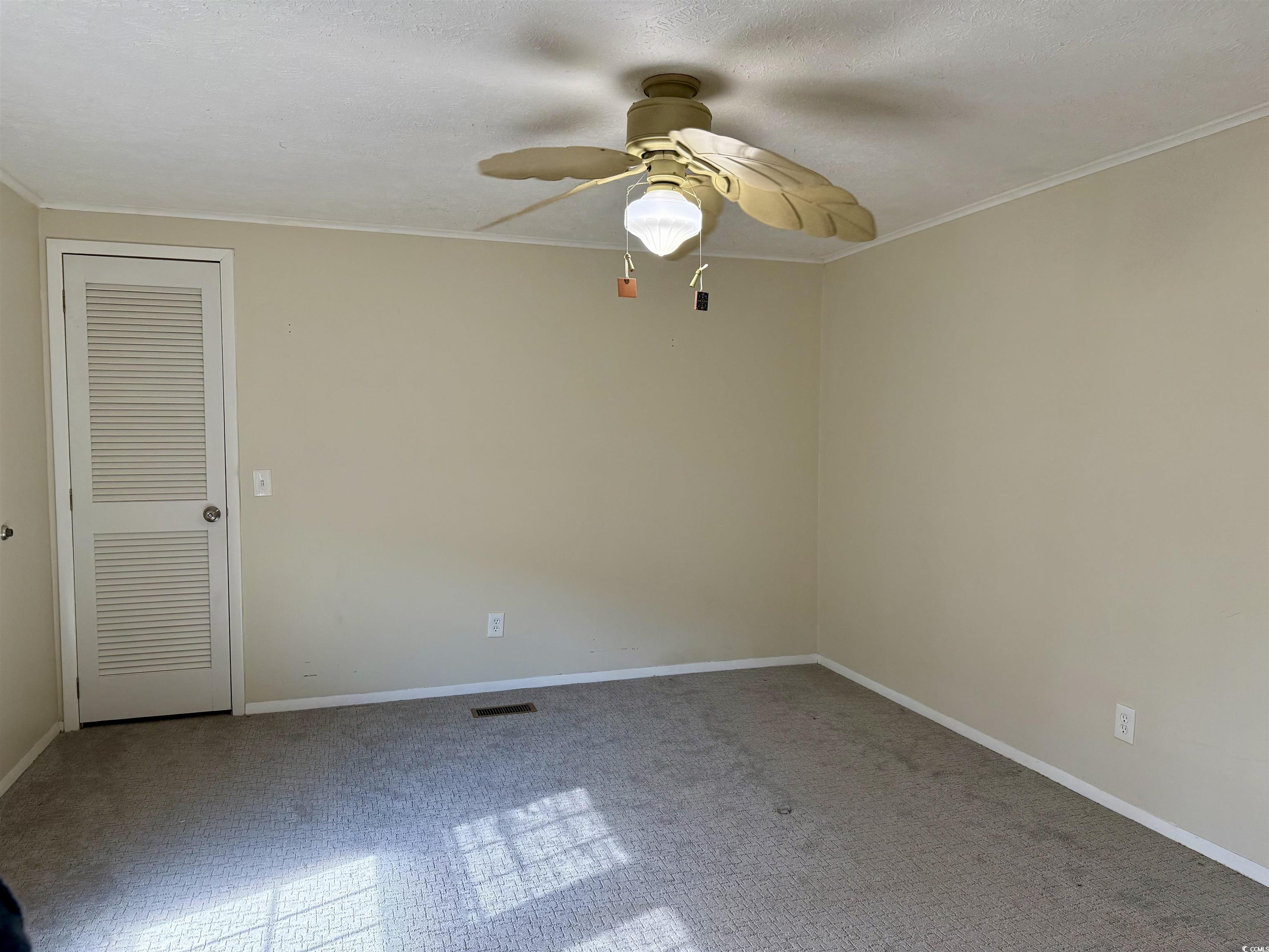 527 Sandpebble Surfside Beach, SC 29575 - Photo 13 of 31 Empty room featuring crown molding and ceiling fan