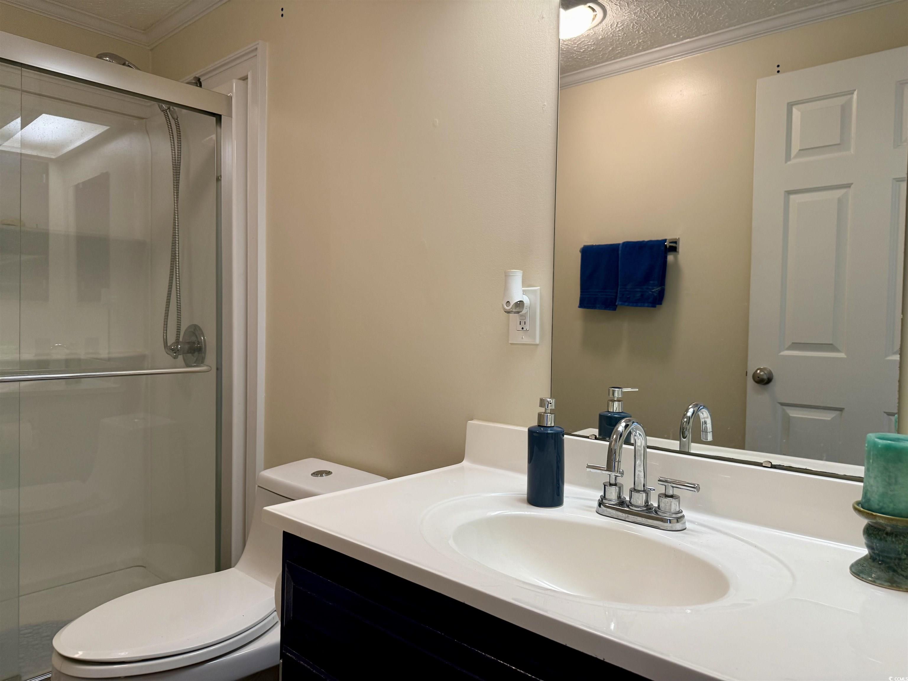 527 Sandpebble Surfside Beach, SC 29575 - Photo 15 of 31 Bathroom featuring vanity, a textured ceiling, orn