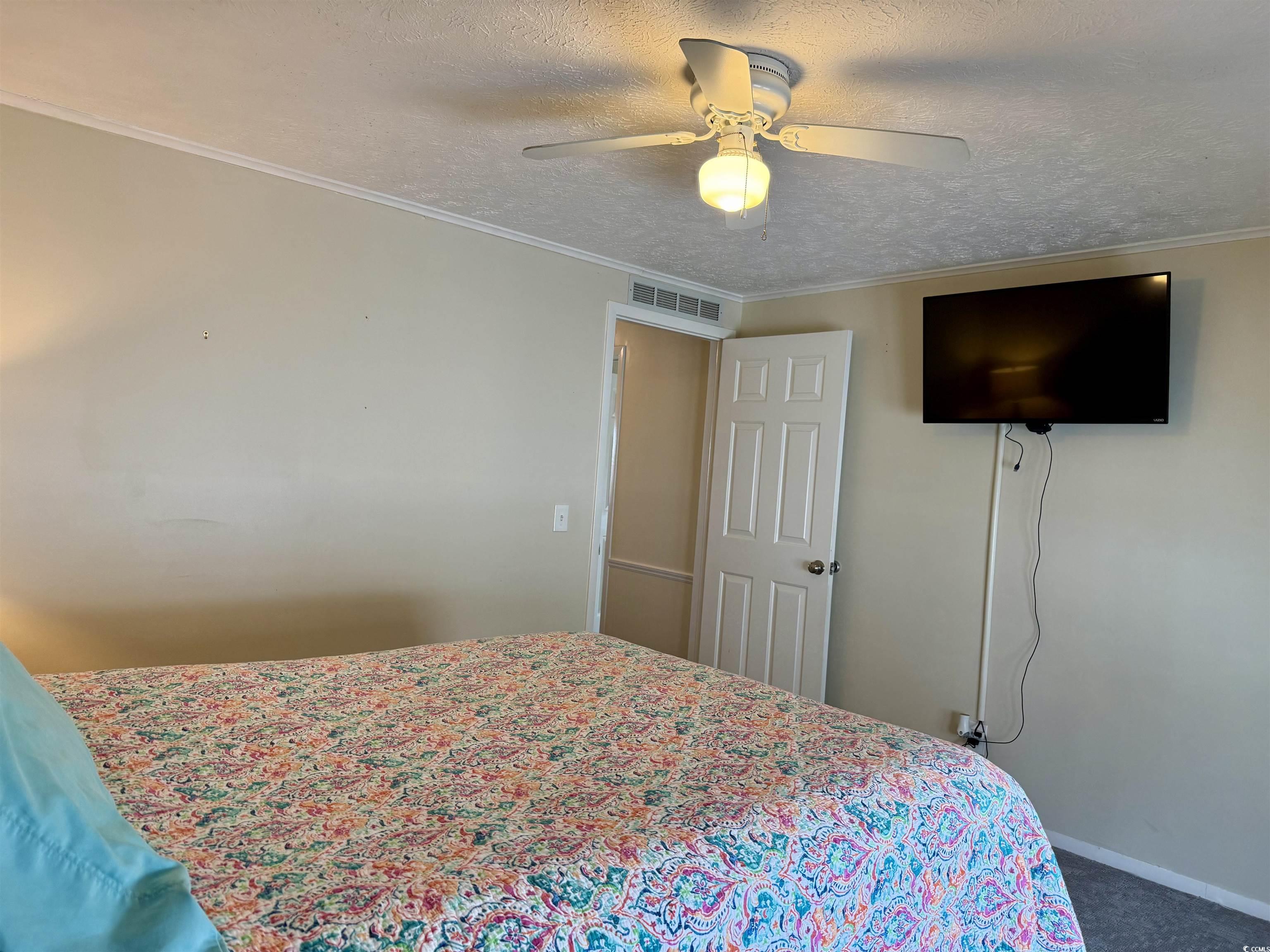 527 Sandpebble Surfside Beach, SC 29575 - Photo 18 of 31 Carpeted bedroom with crown molding, ceiling fan,