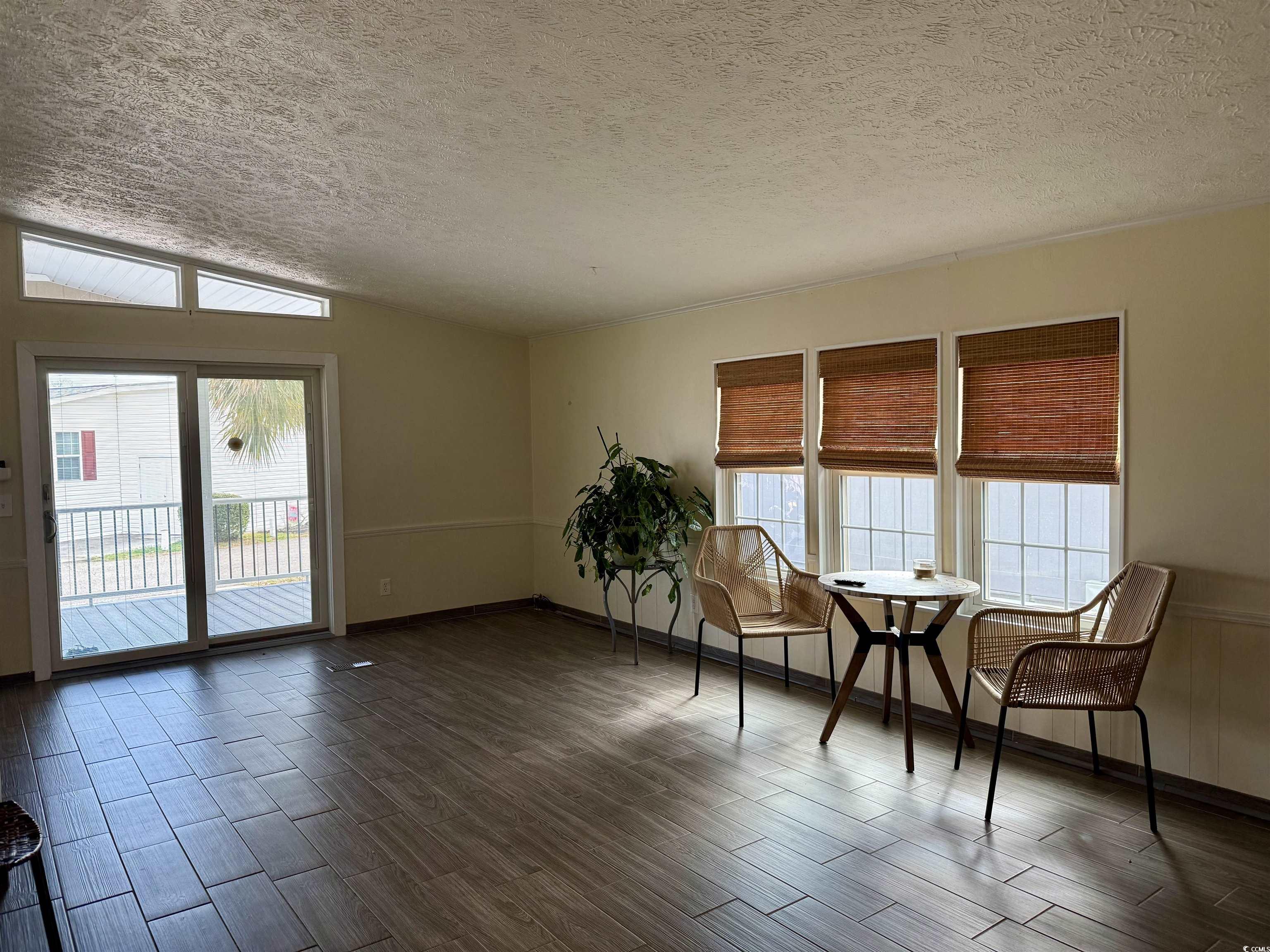 527 Sandpebble Surfside Beach, SC 29575 - Photo 24 of 31 Unfurnished room with lofted ceiling, dark hardwoo