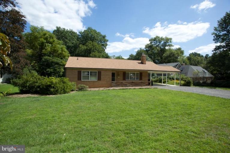 2057 Rockingham Street McLean, VA 22101 - Photo 1 of 14 a front view of a house with a garden