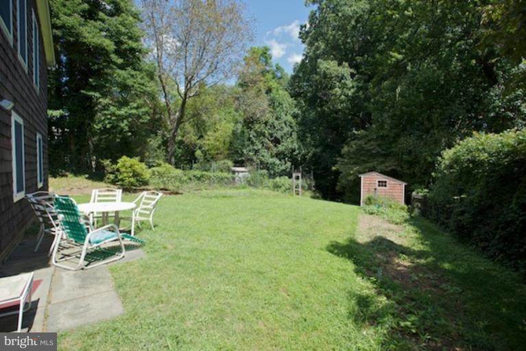 2057 Rockingham Street McLean, VA 22101 - Photo 3 of 14 a backyard of a house with a yard table and chairs
