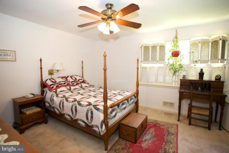2057 Rockingham Street McLean, VA 22101 - Photo 6 of 14 a bedroom with a bed and a chandelier