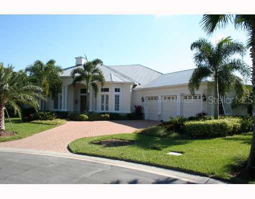 7319 Desert Ridge Glen Lakewood Ranch, FL 34202 - Photo 1 of 1 a front view of a house with a garden and palm trees