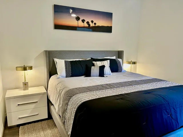 a bedroom with a bed and a flat screen tv