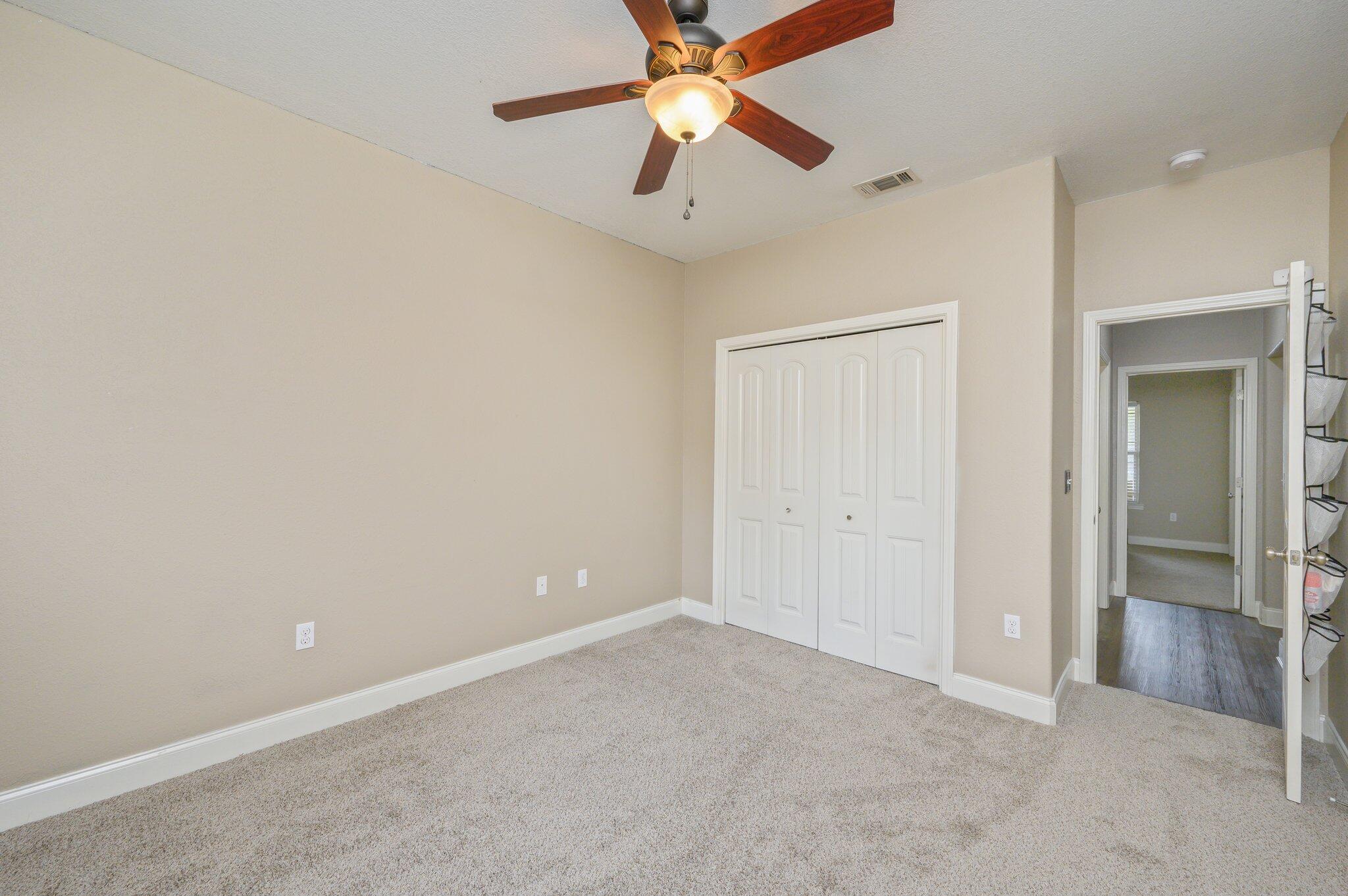 4545 Hermosa Road Crestview, FL 32539 - Photo 23 of 36 an empty room with closet and a chandelier fan