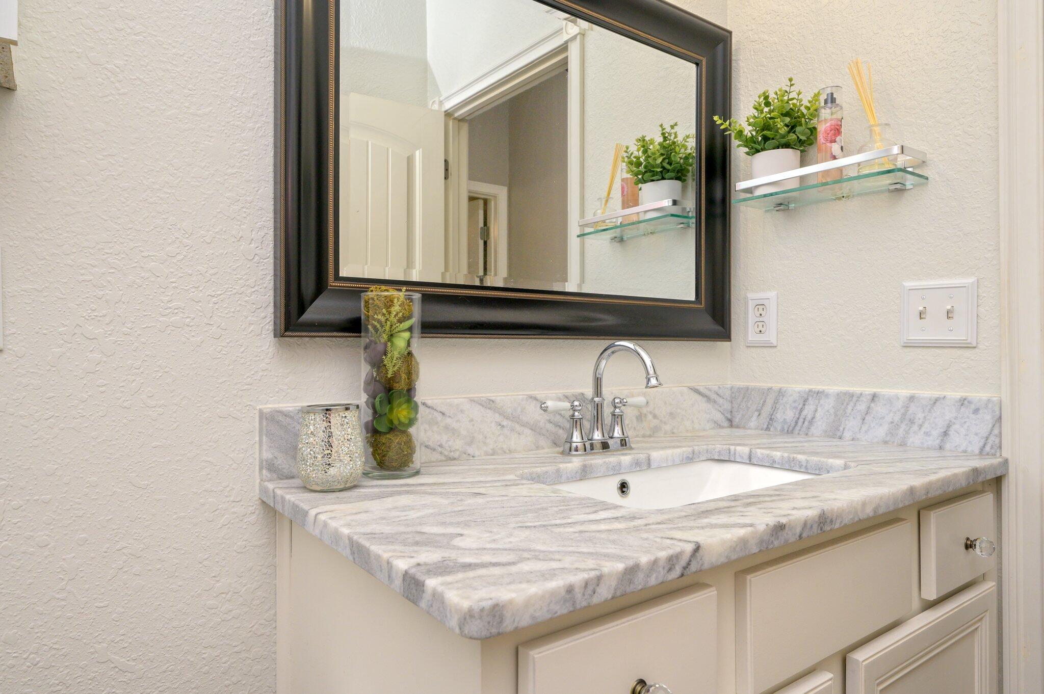 4545 Hermosa Road Crestview, FL 32539 - Photo 26 of 36 a bathroom with a sink and a mirror