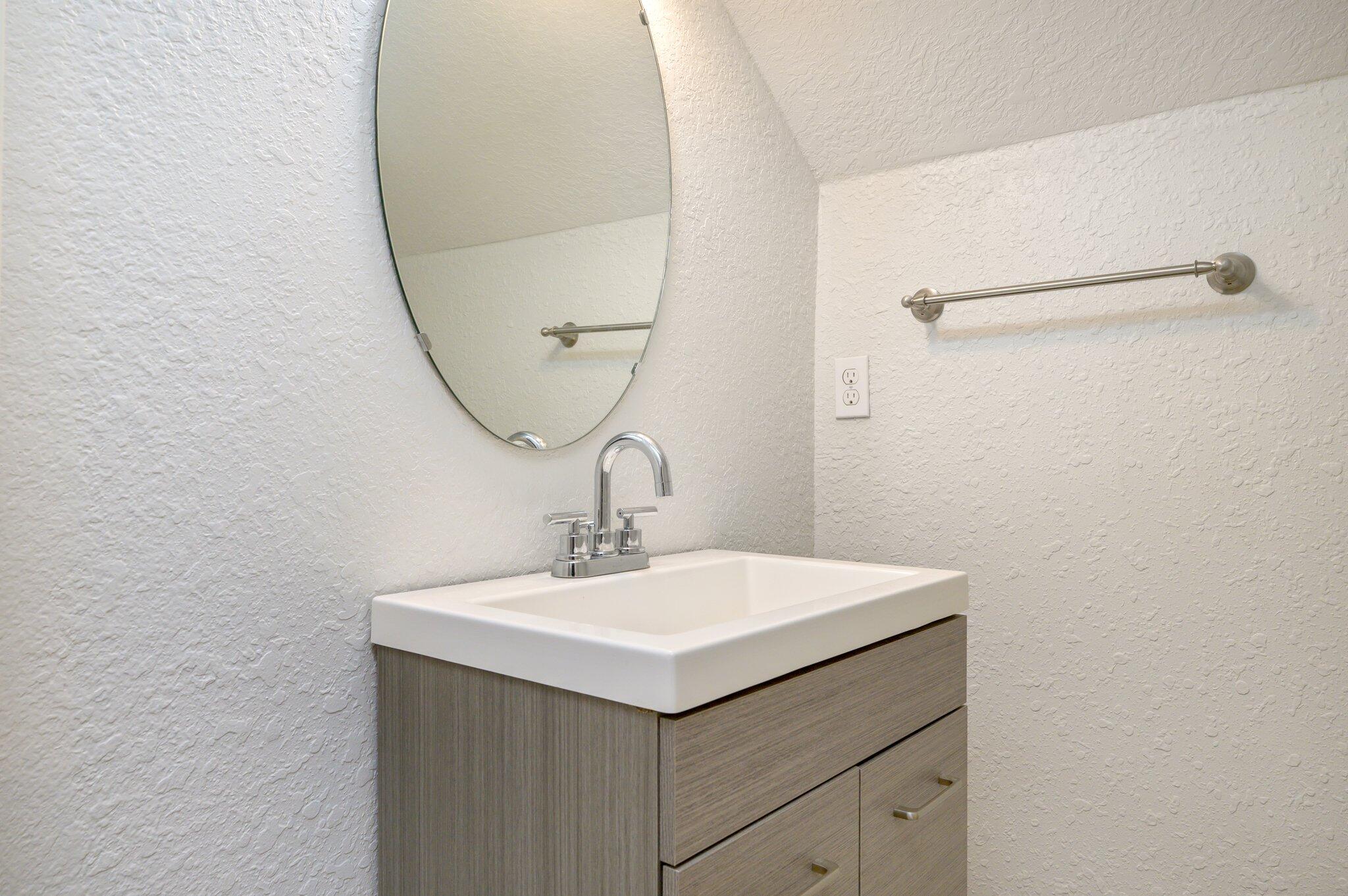 4545 Hermosa Road Crestview, FL 32539 - Photo 29 of 36 a bathroom with a sink and mirror