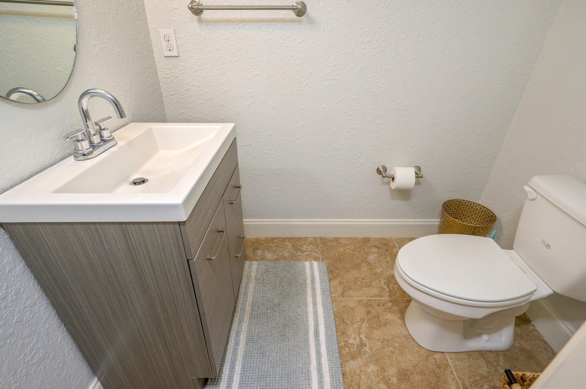 4545 Hermosa Road Crestview, FL 32539 - Photo 30 of 36 a bathroom with a sink a toilet and a mirror