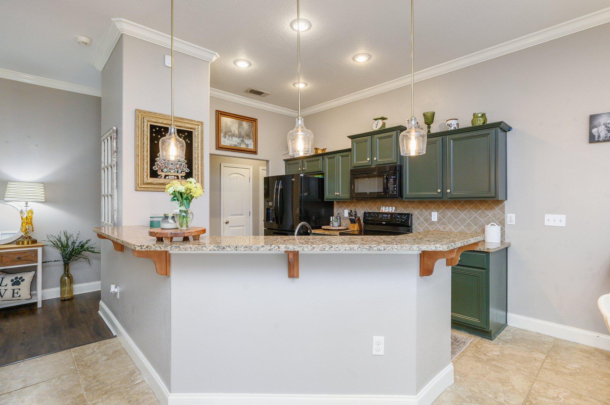 4545 Hermosa Road Crestview, FL 32539 - Photo 8 of 36 a kitchen with stainless steel appliances kitchen island granite countertop a sink and cabinets