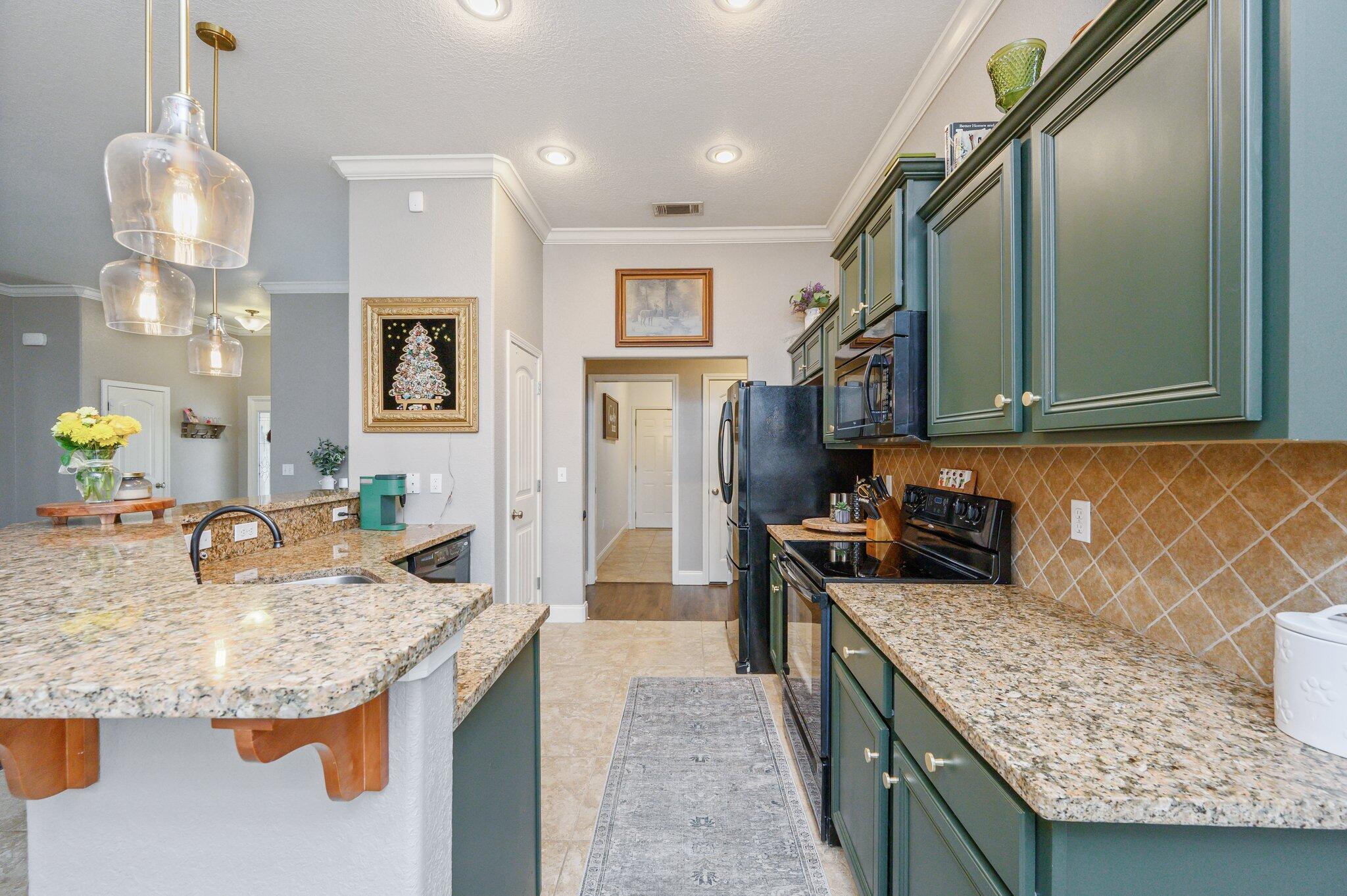 4545 Hermosa Road Crestview, FL 32539 - Photo 9 of 36 a kitchen with granite countertop a sink and a stove